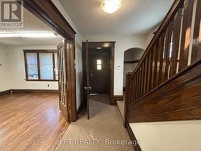 Ottawa apartment for rent - A hallway with wood floors and a staircase.