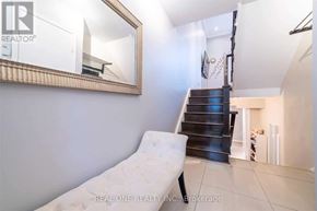 Toronto (St. Andrew-Windfields) townhouse for rent - A white chair is placed in a room with a mirror on the wall.