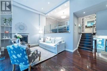 Toronto (St. Andrew-Windfields) townhouse for rent - A living room with a blue chair and a white couch.