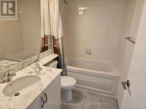 Toronto (Niagara) condo for rent - A white bathroom with a marble sink and a white tub.