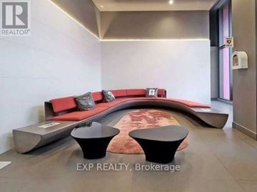 Toronto (Church-Yonge Corridor) condo for rent - A modern living room with a red couch and black ottoman.