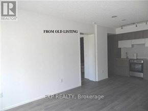Toronto (Church-Yonge Corridor) condo for rent - A room with a kitchen area in the background and a doorway leading to another room.