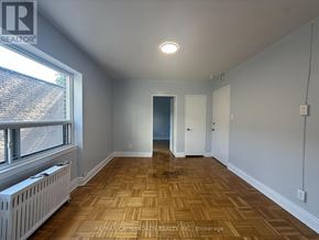 Toronto (Lawrence Park South) condo for rent - A room with wooden flooring and a window with blinds.
