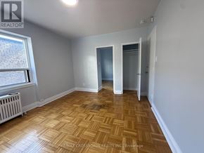 Toronto (Lawrence Park South) condo for rent - A room with wooden flooring and white walls, with a window on the left side.