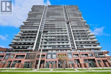 Oshawa (Windfields) condo for rent - A tall residential building with a glass facade and a red brick building in front of it.