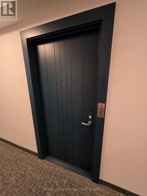 Oshawa (Windfields) condo for rent - A black door with a silver handle and lock.