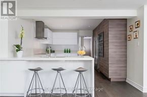 Oakville (Ga Glen Abbey) apartment for rent - A modern kitchen with a bar stool.