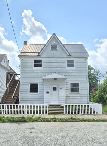 New Kensington apartment for rent - A white house with a grey roof and a white fence in front.