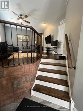 Whitby (Williamsburg) apartment for rent - A staircase with a black railing and wooden steps.