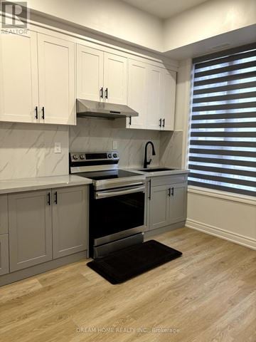 Toronto (Church-Yonge Corridor) apartment for rent - A kitchen with white cabinets and a black mat on the floor.
