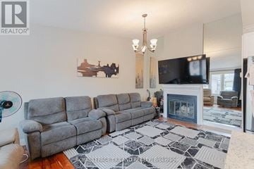 London North (North P) townhouse for rent - A living room with a grey sofa and a fireplace.
