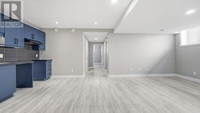 Russell apartment for rent - A spacious kitchen with blue cabinets and a white doorway leading to another room.