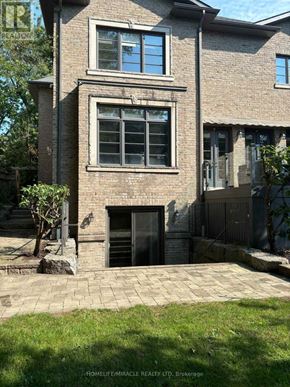 Toronto (Edenbridge-Humber Valley) apartment for rent - A brick house with a black door and windows.