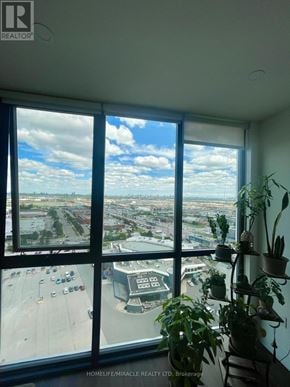 Vaughan (Concord) condo for rent - A room with a view of a parking lot and buildings.