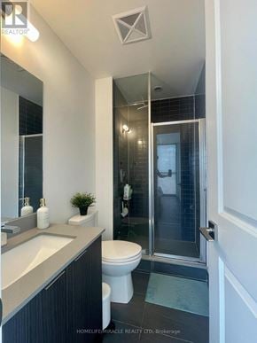 Vaughan (Concord) condo for rent - A bathroom with a toilet, sink, and shower.
