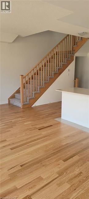 Mount Hope townhouse for rent - A wooden staircase with a white wall on one side.