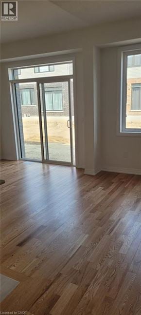 Mount Hope townhouse for rent - A room with wooden flooring and a sliding glass door.