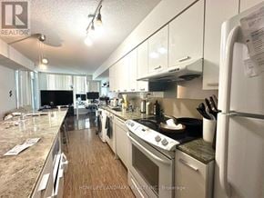 Toronto (Bayview Village) condo for rent - A kitchen with a refrigerator, stove, and oven.