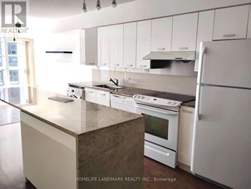 Toronto (Bayview Village) condo for rent - A kitchen with white cabinets and appliances.