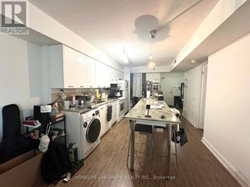 Toronto (Bayview Village) condo for rent - A kitchen with a table and chairs in the middle of it.