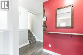 Kitchener apartment for rent - A red wall with a mirror and a staircase.