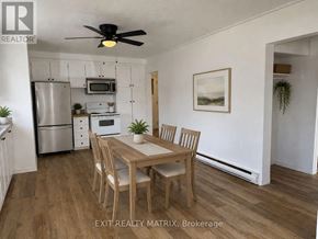 Casselman apartment for rent - A dining room with a table and chairs and a refrigerator in the background.