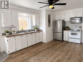 Casselman apartment for rent - A kitchen with white cabinets and a wood floor.