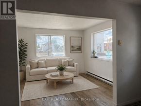 Casselman apartment for rent - A living room with a couch, a coffee table, and a plant.