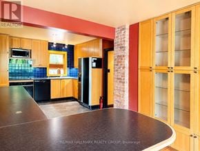 Ottawa apartment for rent - A kitchen with wooden cabinets and a brick wall.