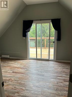 Woodstock (Woodstock - North) multi-family for rent - A room with a sliding glass door leading to a balcony.