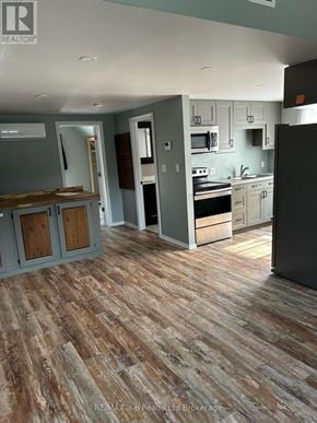Woodstock (Woodstock - North) multi-family for rent - A kitchen with a wooden floor and a refrigerator.