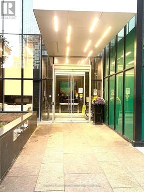 Toronto (Lansing-Westgate) condo for rent - A glass door entrance to a building with a sign that says REALTOR.