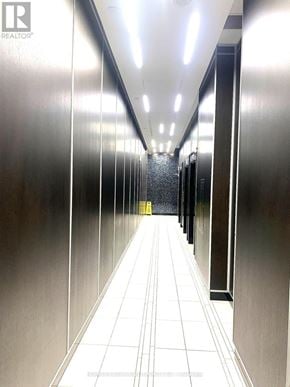 Toronto (Lansing-Westgate) condo for rent - A long hallway with a yellow caution sign at the end.