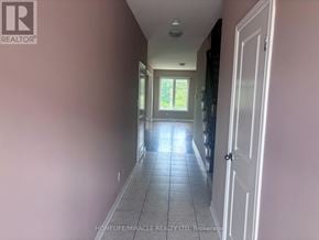 Hamilton (Lakeshore) townhouse for rent - A long hallway with a door on the right.