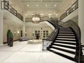 Toronto (Newtonbrook West) condo for rent - A grand staircase with a black railing and white steps leads up to a balcony.