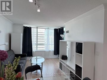 Toronto (Newtonbrook West) condo for rent - A living room with a glass table and a grey couch.