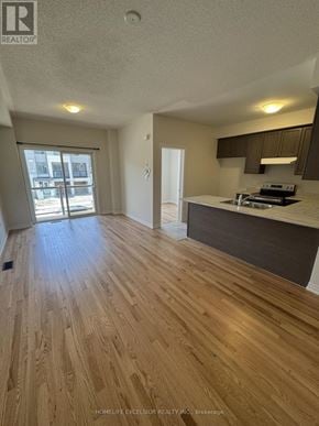 Newmarket (Woodland Hill) townhouse for rent - A kitchen with wooden floors and a countertop.