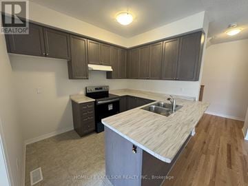 Newmarket (Woodland Hill) townhouse for rent - A kitchen with a sink and cabinets.