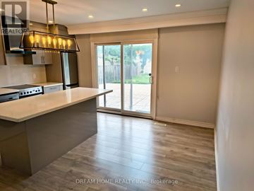 Toronto (Yorkdale-Glen Park) apartment for rent - A kitchen with a counter top and a sliding glass door.