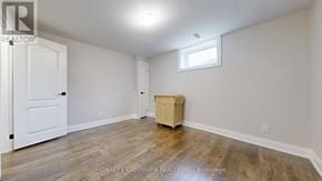 East Gwillimbury (Sharon) apartment for rent - A room with a wooden floor and a white door.