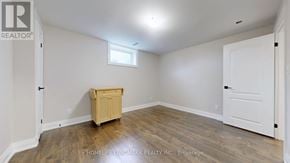 East Gwillimbury (Sharon) apartment for rent - A room with a wooden floor and white walls, with a small window and a wooden cabinet.