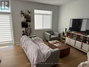 Belleville (Thurlow Ward) townhouse for rent - A living room with a couch, chair, and television.