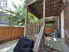 Toronto (Lawrence Park South) duplex for rent - A wooden deck with a black tarp on it.