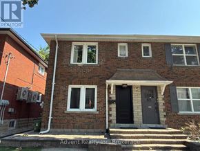 Toronto (Lawrence Park South) duplex for rent - A house with a black door and white windows is for sale.