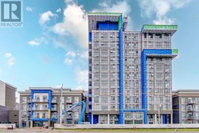 Hamilton (Waterdown) condo for rent - A large building with a blue and green facade is under construction.