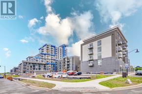 Hamilton (Waterdown) condo for rent - A large building under construction with a clear blue sky in the background.