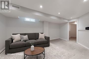 Burlington (Uptown) apartment for rent - A living room with a grey couch and a coffee table.