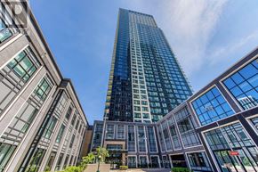Toronto (Islington-City Centre West) condo for rent - A modern glass building stands tall in the skyline.