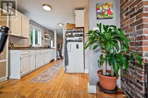 Orangeville apartment for rent - A kitchen with wooden floors and white cabinets.