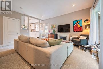 Orangeville apartment for rent - A living room with a beige couch and a painting on the wall.